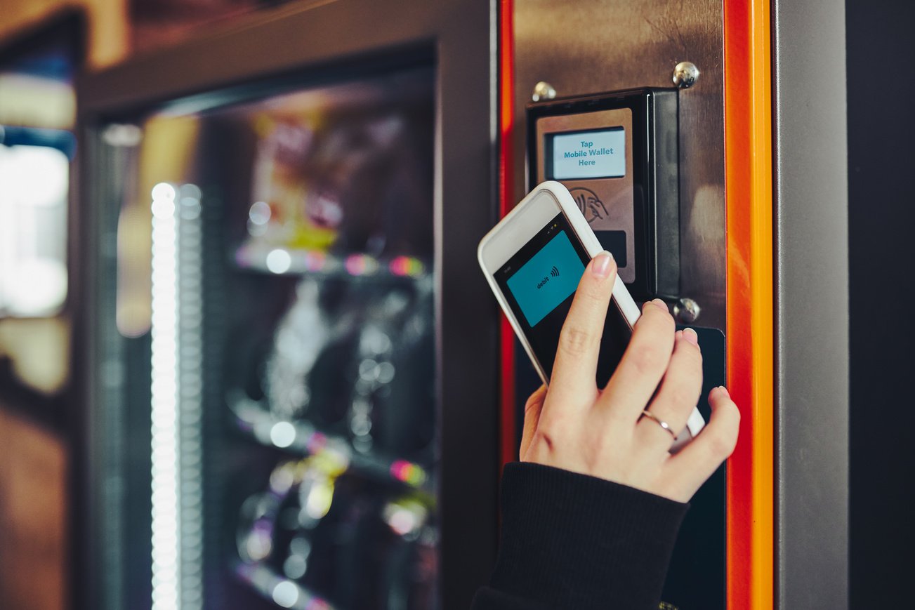 Woman Paying for Product at Vending Machine Using Smartphone